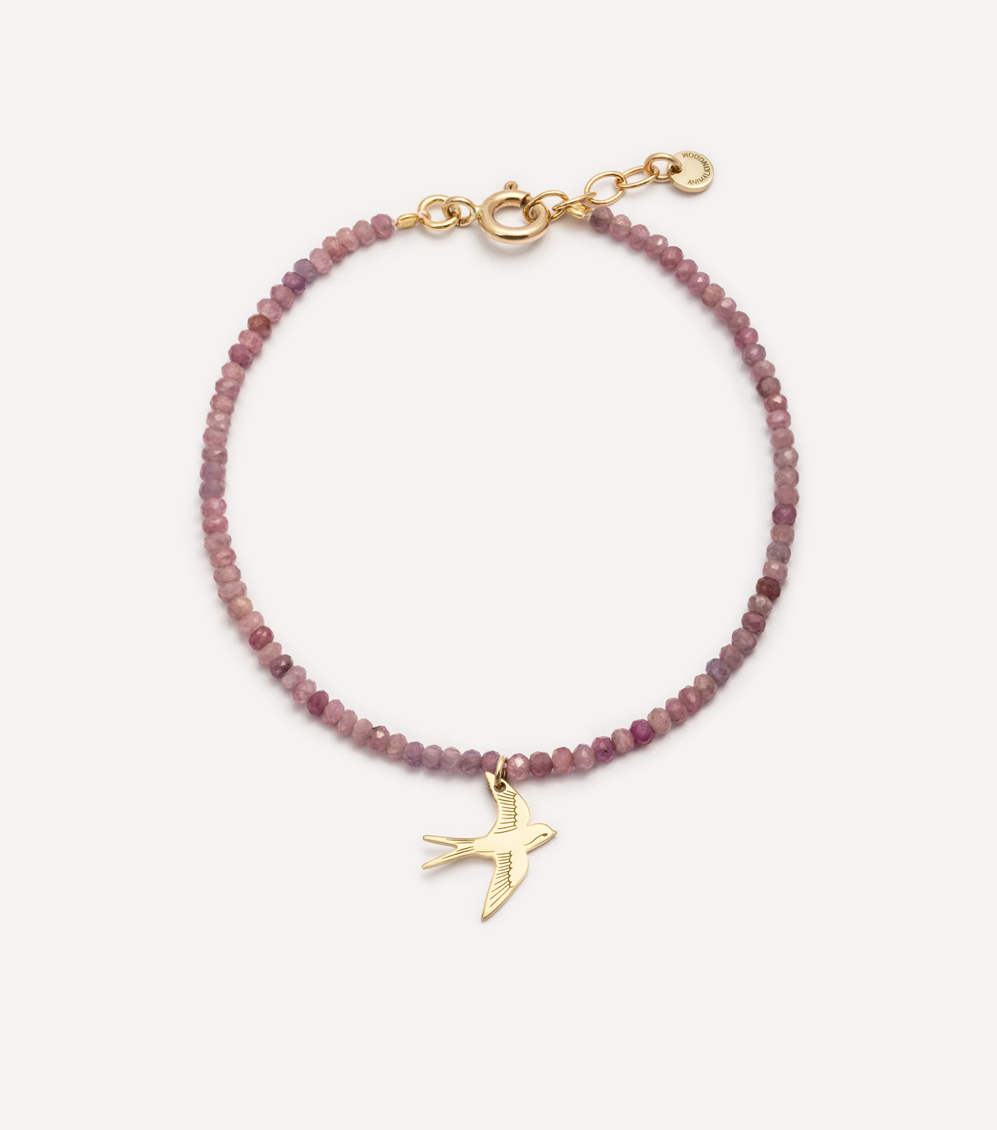 Złota bransoletka z kamieniami i zawieszką