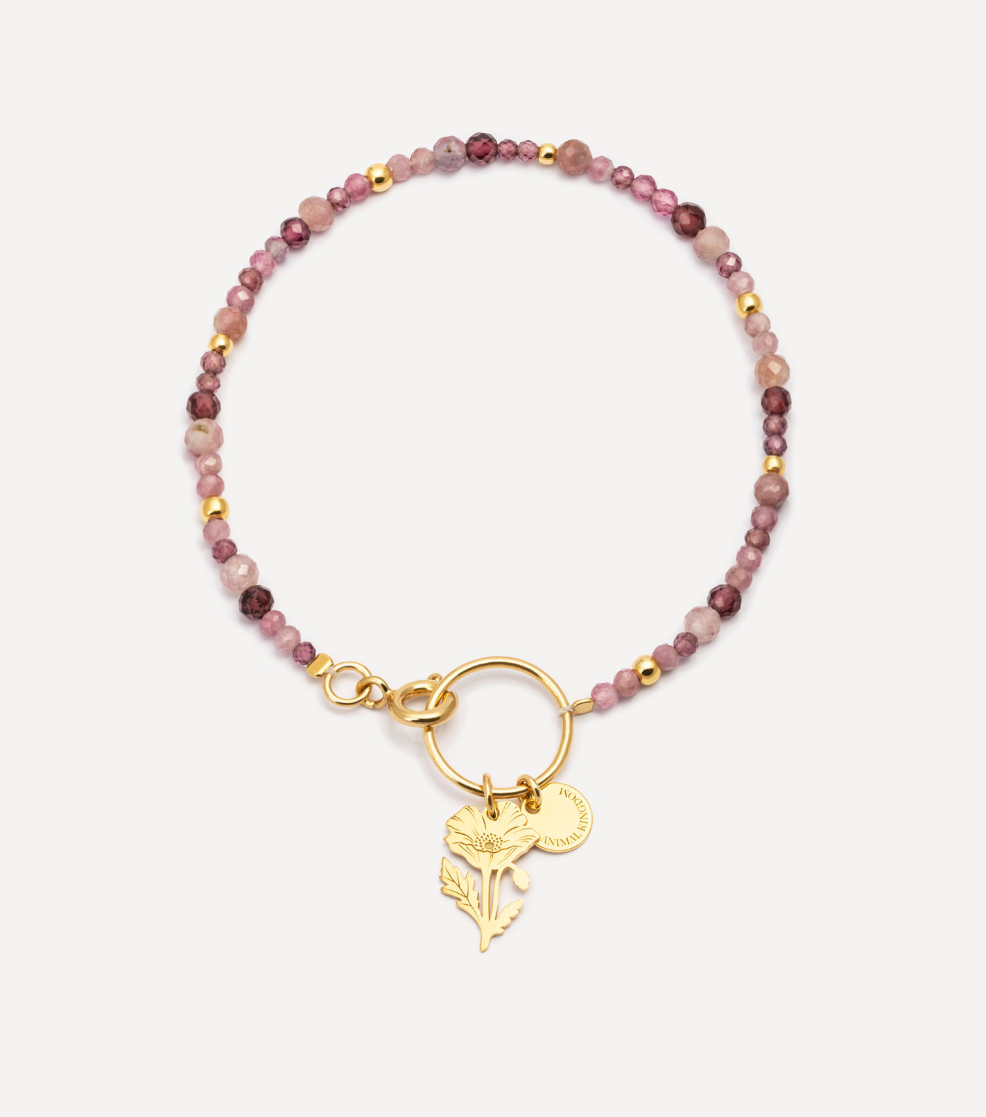 Pozłacana bransoletka z kamieniami i zawieszką