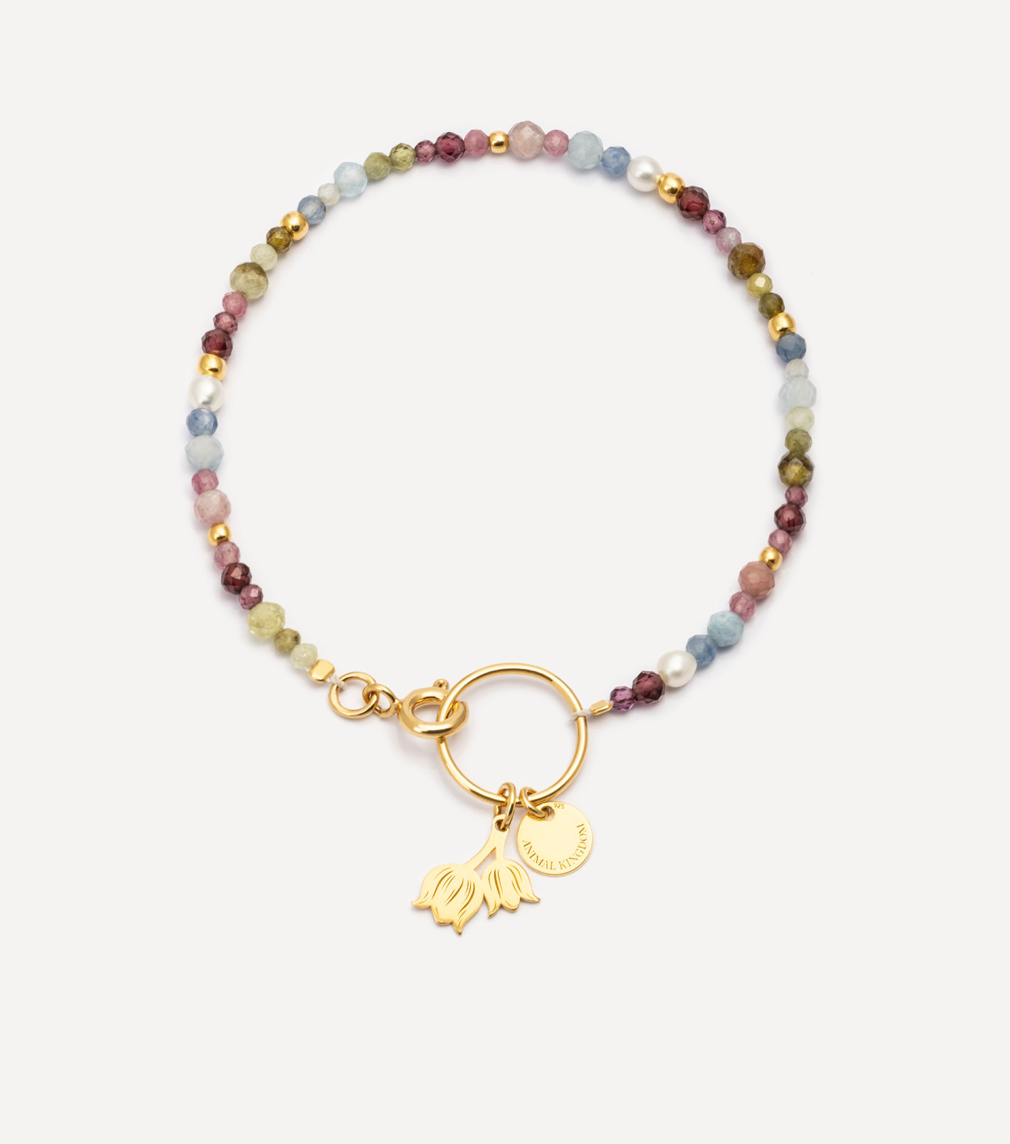 Pozłacana bransoletka z kamieniami i zawieszką